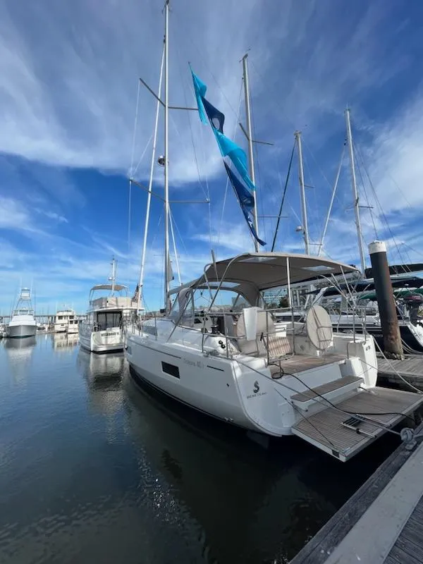 Slide: The Image of 2023 Beneteau Oceanis 40.1 yacht docked at marina under blue sky. - 5