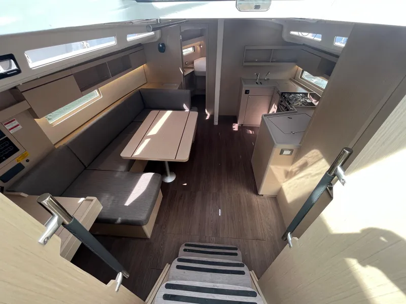 Slide: The Image of Modern interior of 2023 Beneteau Oceanis 40.1 yacht with dining area and kitchen. - 9