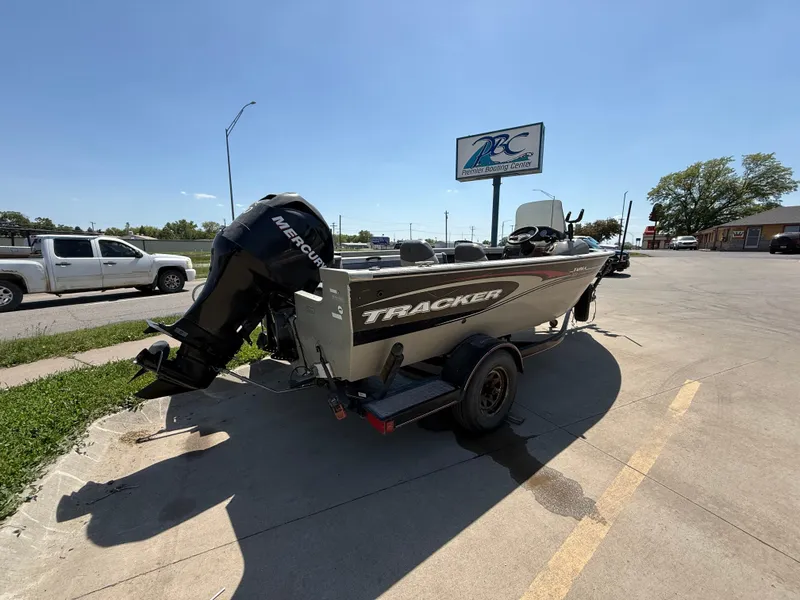 Slide: The Image of 2003 Tracker Targa 18 SC boat with Mercury engine on trailer in parking lot. - 2