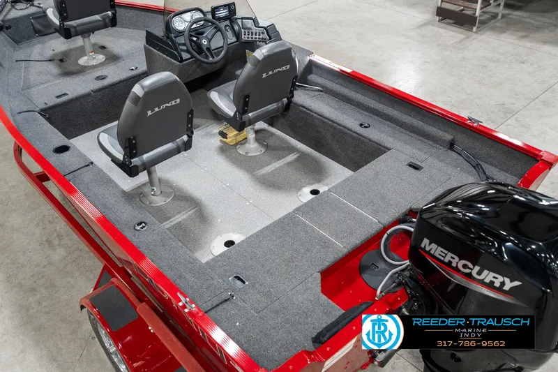 Slide: The Image of 2021 Lund 1650 ANG SS boat interior with Mercury engine, featuring dual seats and steering console. - 13