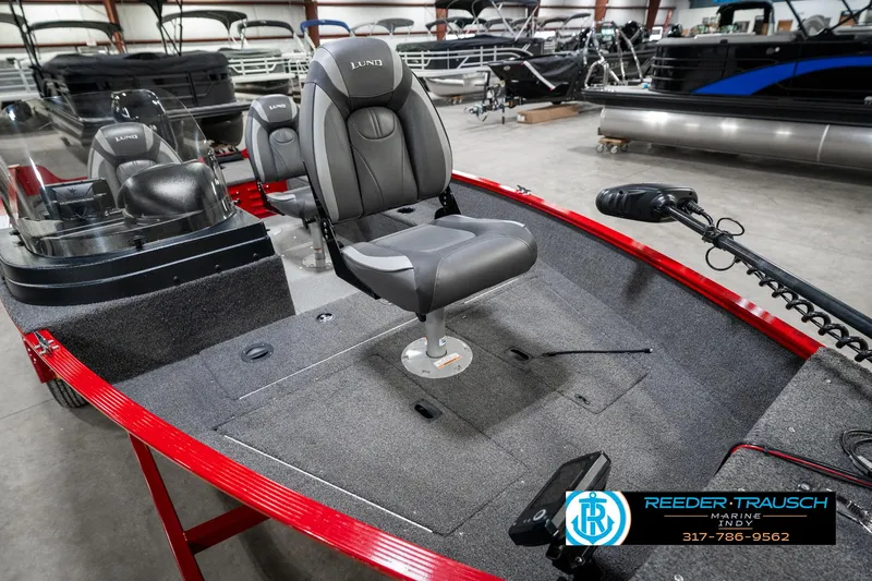 Slide: The Image of 2021 Lund 1650 ANG SS boat interior with seating and control panel in showroom. - 18