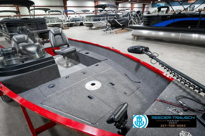 Slide: The Image of 2021 Lund 1650 ANG SS fishing boat interior in showroom, featuring seating and storage. - 19