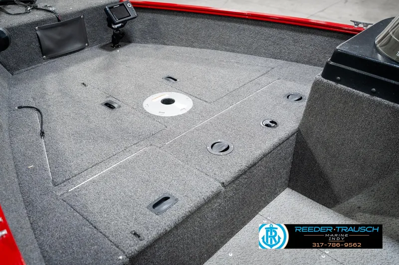 Slide: The Image of 2021 Lund 1650 ANG SS boat interior with carpeted deck and storage compartments. - 21