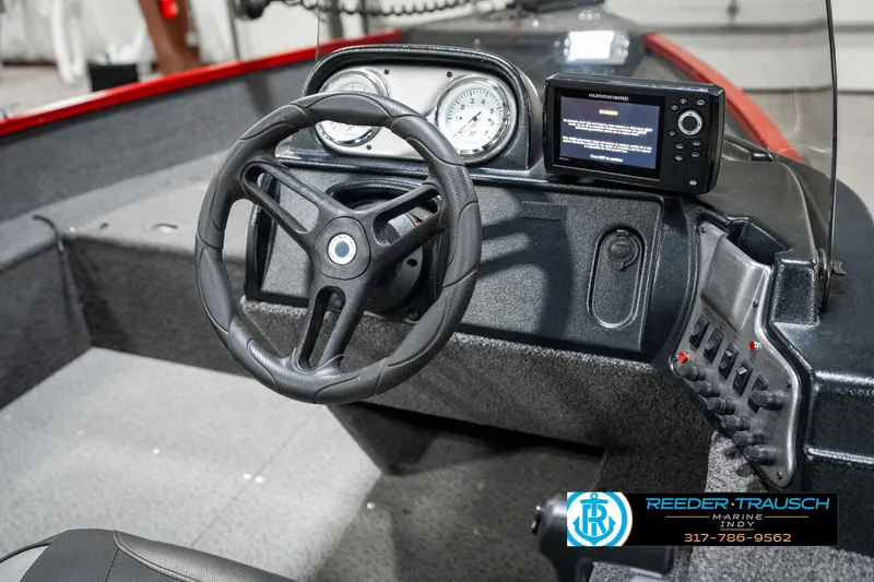 Slide: The Image of 2021 Lund 1650 ANG SS boat dashboard with steering wheel and electronic display. - 25
