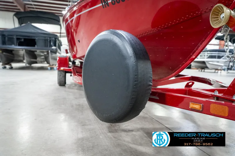 Slide: The Image of Red 2021 Lund 1650 ANG SS boat on trailer in indoor storage facility. - 47