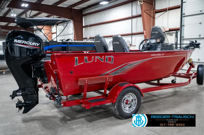 Slide: The Image of 2021 Lund 1650 ANG SS red fishing boat with Mercury engine in a showroom. - 6
