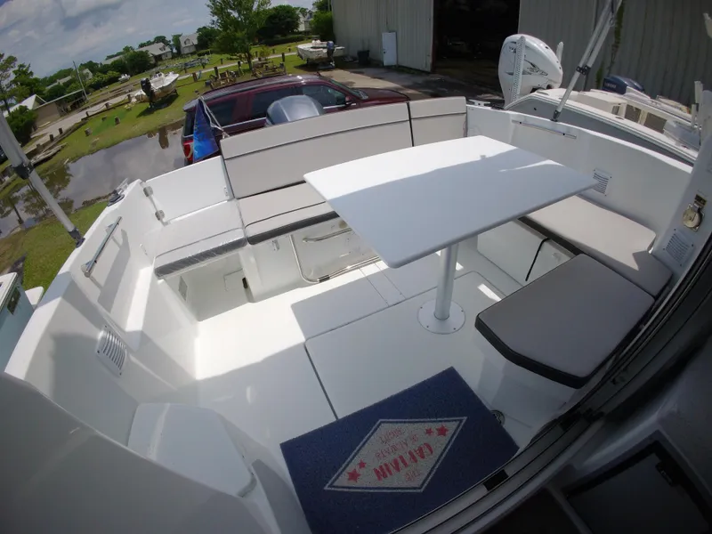 Slide: The Image of 2022 Jeanneau NC 695 Series 2 boat interior with seating and table. - 1