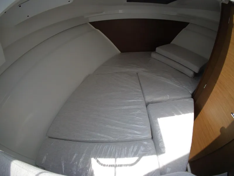 Slide: The Image of Interior cabin of 2022 Jeanneau NC 695 Series 2, featuring cushioned seating. - 14