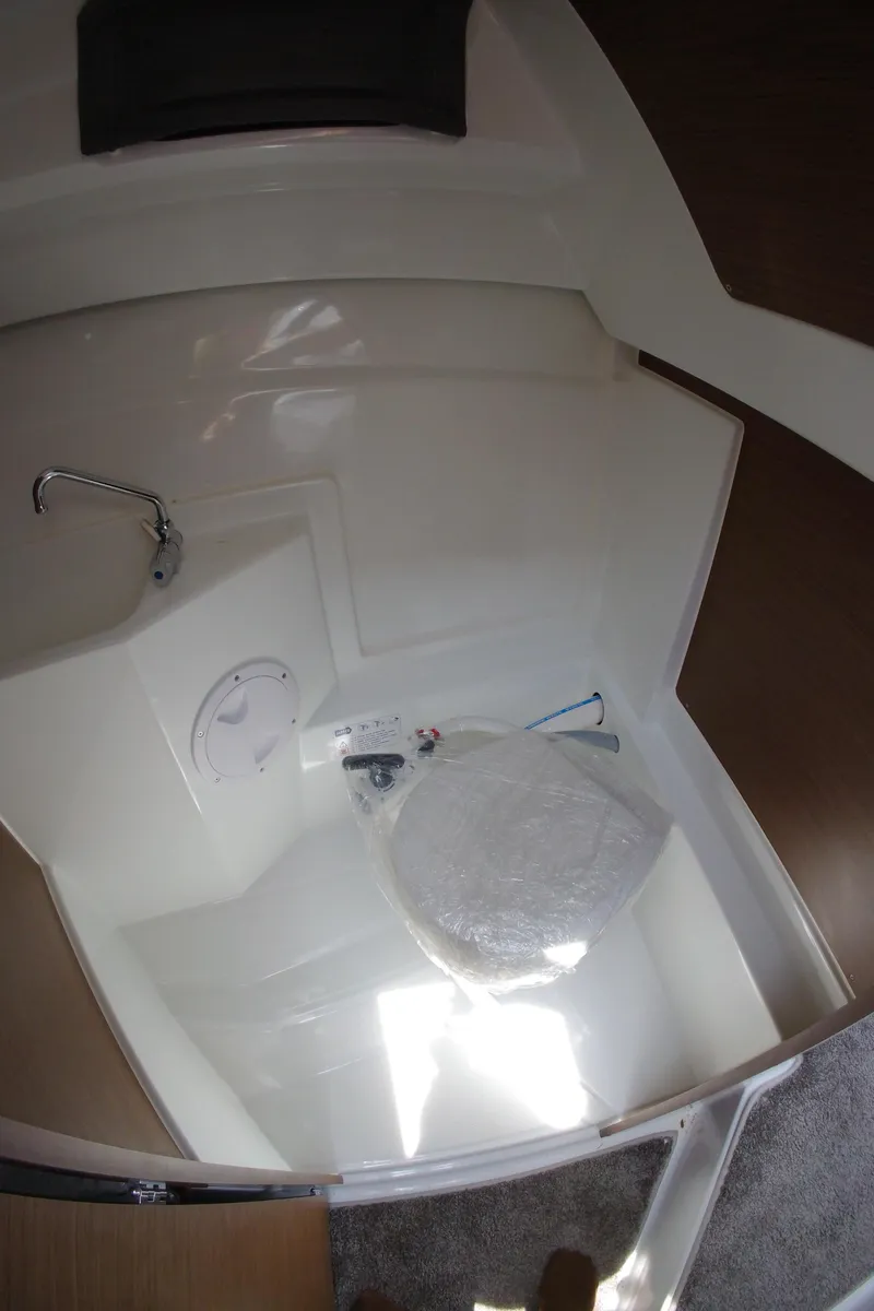 Slide: The Image of Interior cabin of 2022 Jeanneau NC 695 Series 2 boat, featuring a cozy sleeping area. - 16