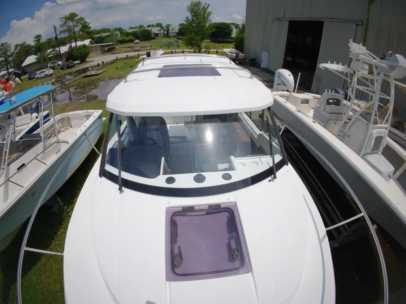 Slide: The Image of Interior of 2022 Jeanneau NC 695 Series 2 boat, featuring a compact bathroom setup. - 18