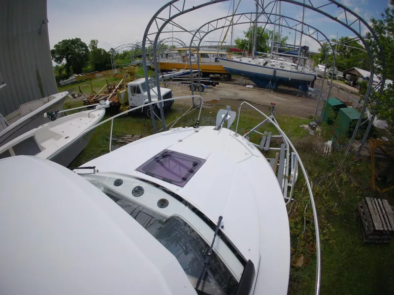 Slide: The Image of 2022 Jeanneau NC 695 Series 2 boat docked, top view, surrounded by other boats. - 19