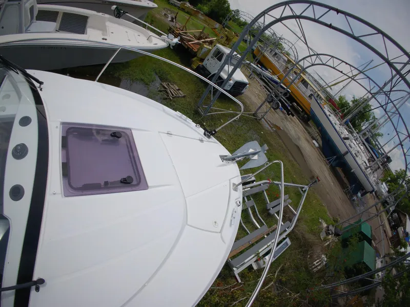 Slide: The Image of 2022 Jeanneau NC 695 Series 2 boat docked near a large warehouse. - 21