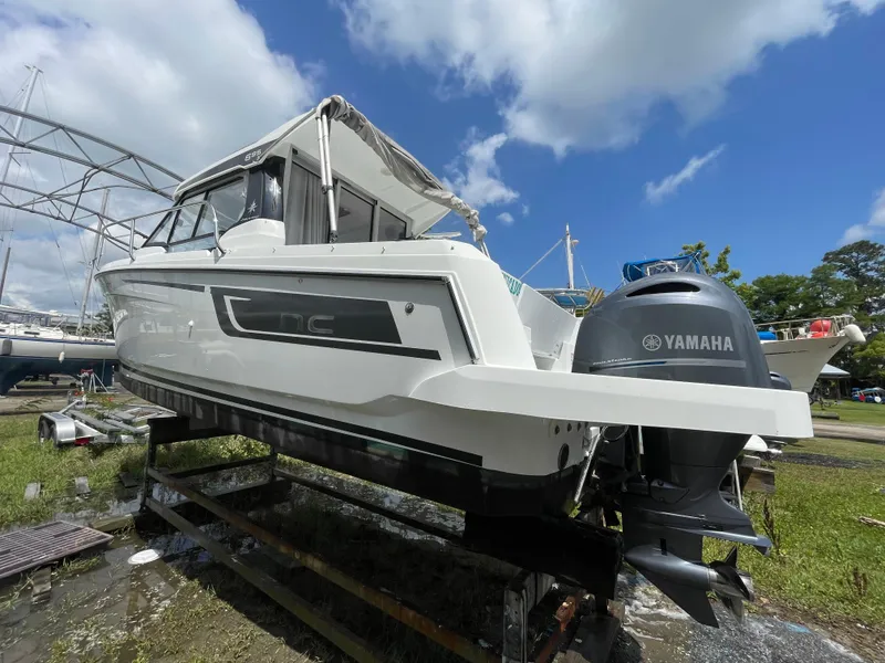 Slide: The Image of 2022 Jeanneau NC 695 Series 2 boat with Yamaha engine, docked outdoors. - 24