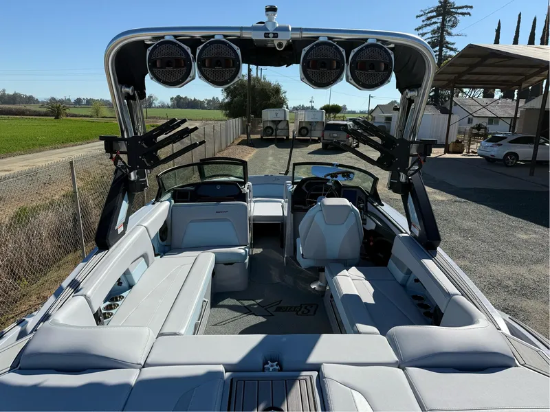 Slide: The Image of 2024 MasterCraft XStar S boat interior with sleek seating and advanced audio system. - 13