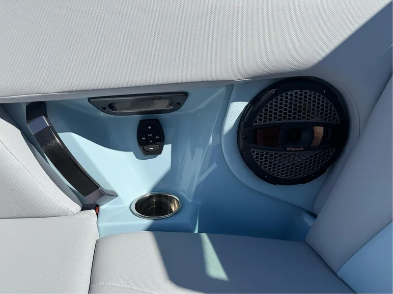 Slide: The Image of 2024 MasterCraft XStar S interior with speaker, control panel, and cup holder. - 26