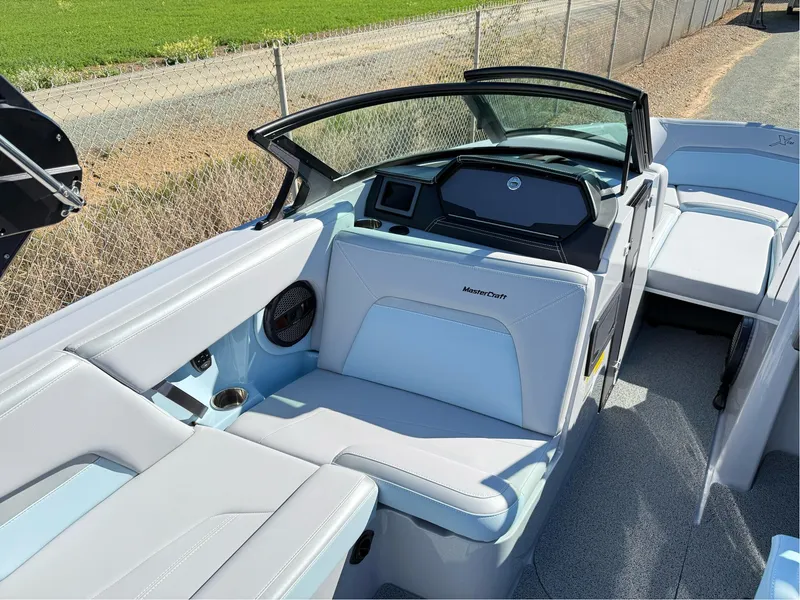 Slide: The Image of 2024 MasterCraft XStar S boat interior with sleek seating and modern dashboard design. - 27