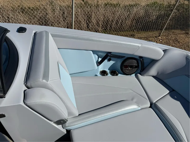 Slide: The Image of 2024 MasterCraft XStar S boat interior with sleek gray and blue seating and speaker system. - 29