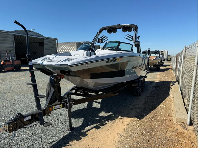 Slide: The Image of 2024 MasterCraft XStar S boat on trailer in outdoor storage area. - 3