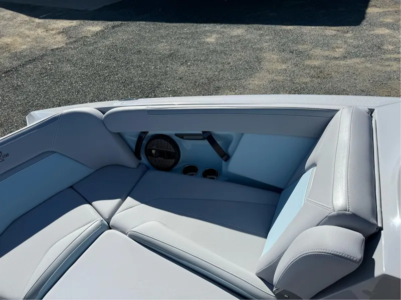 Slide: The Image of 2024 MasterCraft XStar S boat interior with gray seating and speaker system. - 31