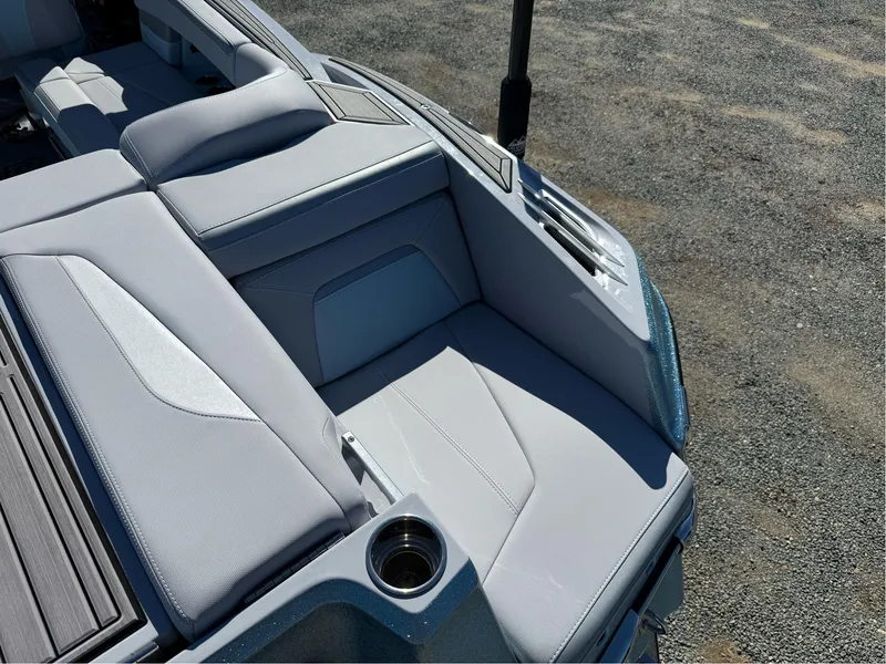 Slide: The Image of 2024 MasterCraft XStar S boat interior with sleek, modern seating and cup holder. - 32
