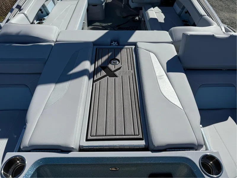 Slide: The Image of 2024 MasterCraft XStar S boat interior with sleek seating and stylish deck design. - 33