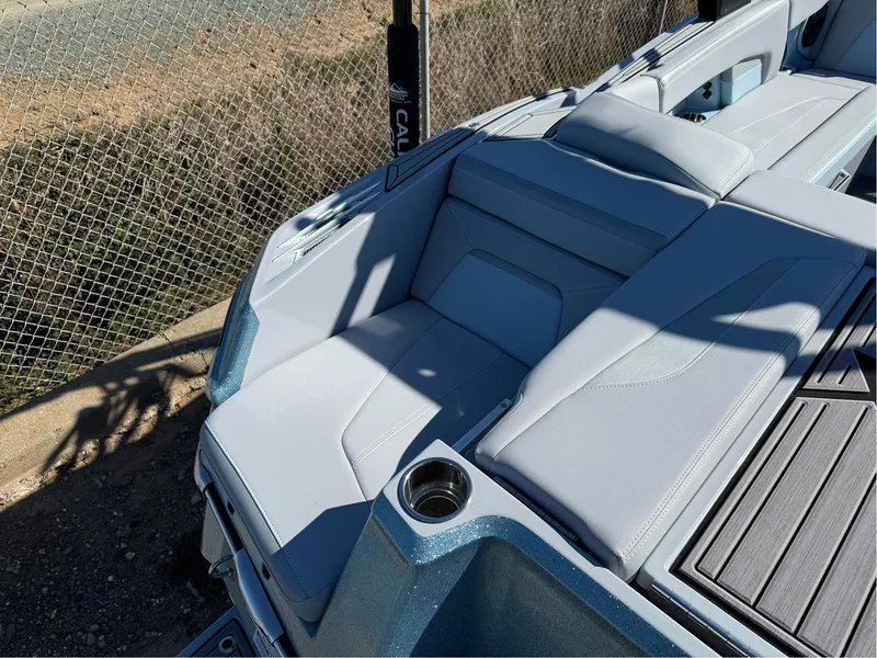 Slide: The Image of 2024 MasterCraft XStar S boat interior with sleek seating and cup holder. - 34