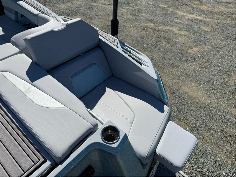 Slide: The Image of 2024 MasterCraft XStar S boat interior with sleek, modern seating and cup holder. - 35
