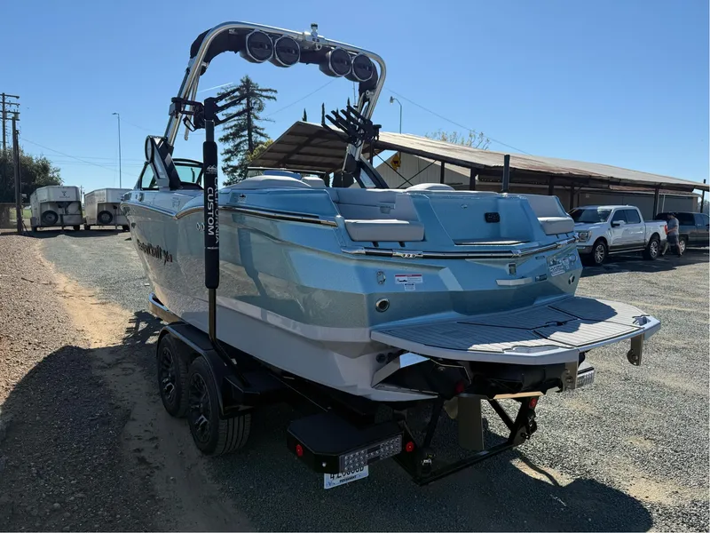 Slide: The Image of 2024 MasterCraft XStar S boat on trailer, rear view, parked outdoors. - 4