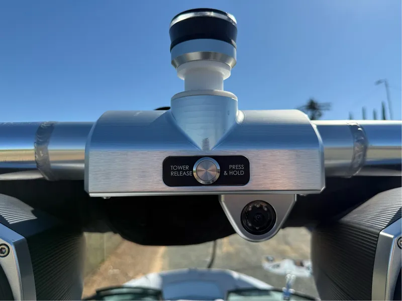 Slide: The Image of 2024 MasterCraft XStar S tower release mechanism with camera, under clear blue sky. - 41