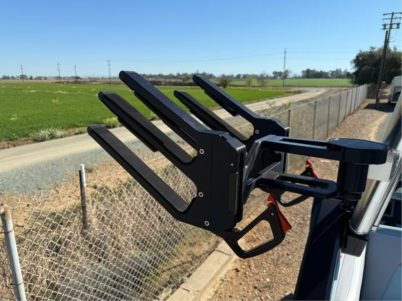 Slide: The Image of Wakeboard rack on 2024 MasterCraft XStar S boat, set against a rural landscape. - 45