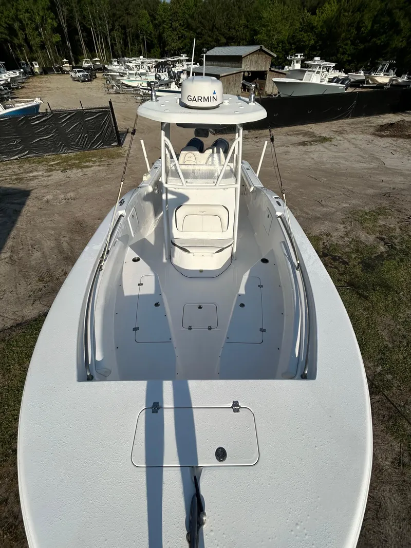 Slide: The Image of 2015 Tidewater 250 CC Adventure boat, aerial view, parked outdoors, featuring Garmin equipment. - 10