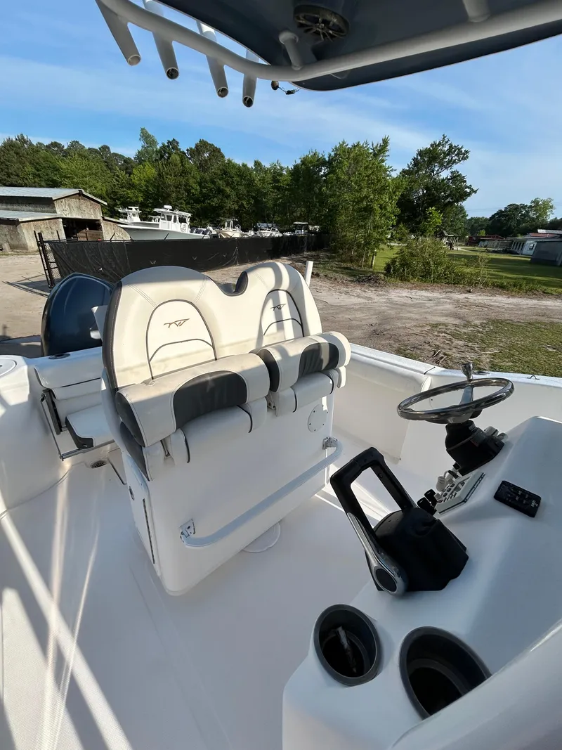 Slide: The Image of 2015 Tidewater 250 CC Adventure boat interior with helm and seating. - 12