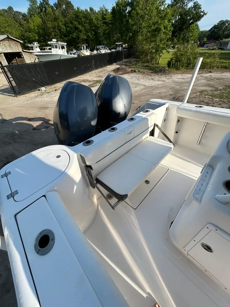 Slide: The Image of 2015 Tidewater 250 CC Adventure boat with dual engines, docked outdoors. - 13