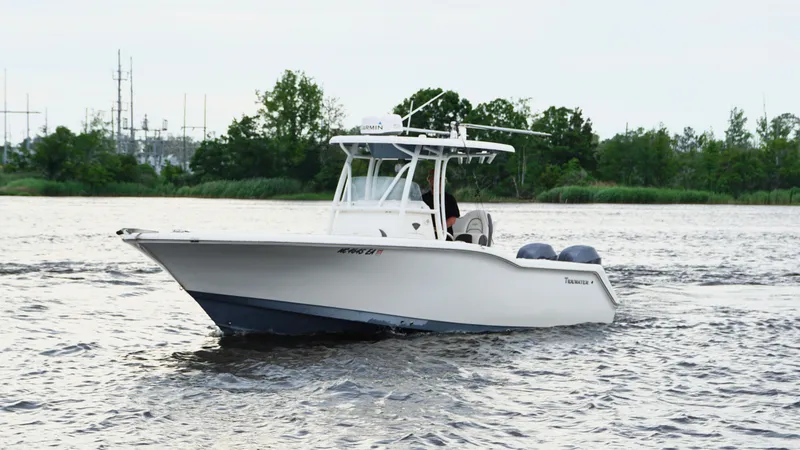 Slide: The Image of 2015 Tidewater 250 CC Adventure boat cruising on a river. - 4