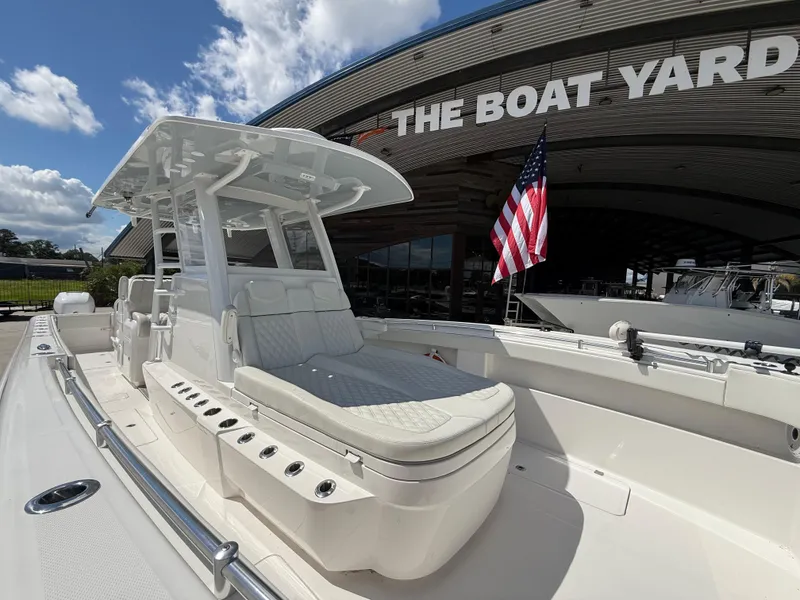 Slide: The Image of 2022 Invincible 33 Catamaran at The Boat Yard, featuring sleek design and American flag. - 11