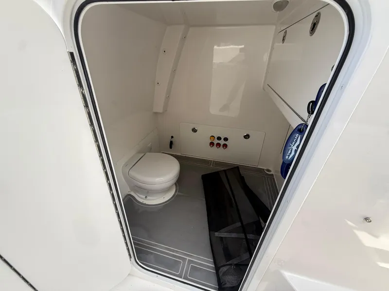 Slide: The Image of 2022 Invincible 33 Catamaran interior bathroom with toilet and control panel. - 15