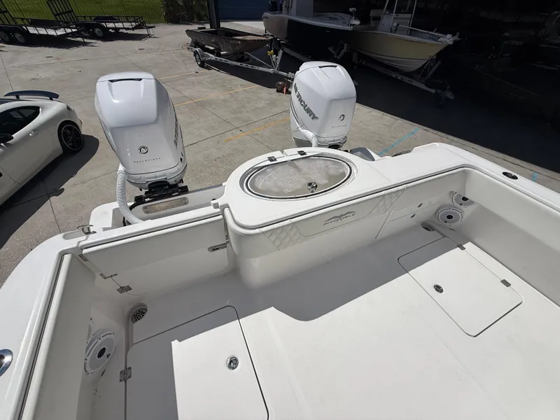 Slide: The Image of 2022 Invincible 33 Catamaran with dual outboard engines, docked in a marina. - 17