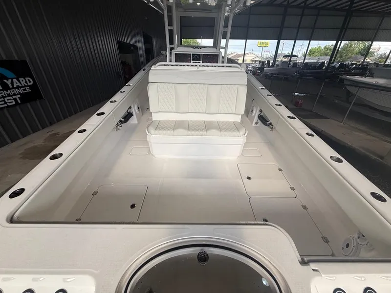 Slide: The Image of 2022 Invincible 33 Catamaran interior with white seating and storage compartments. - 19