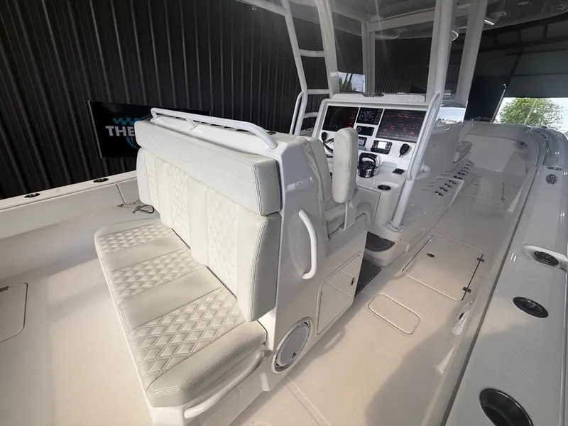 Slide: The Image of 2022 Invincible 33 Catamaran interior with modern seating and advanced control panel. - 24