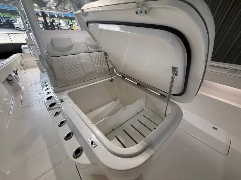 Slide: The Image of 2022 Invincible 33 Catamaran with open storage compartment and seating area. - 34