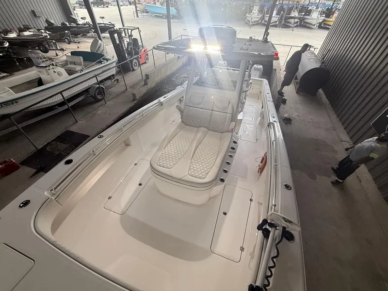 Slide: The Image of 2022 Invincible 33 Catamaran boat interior with cushioned seating in a storage facility. - 37