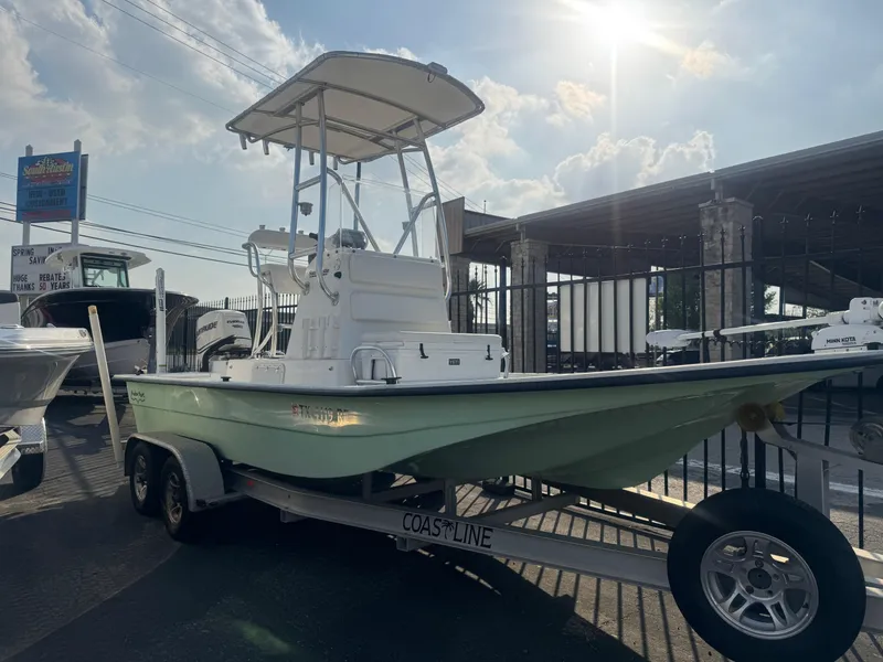 Slide: The Image of 2013 Shallow Sport 21 Sport boat on trailer under sunny sky. - 1