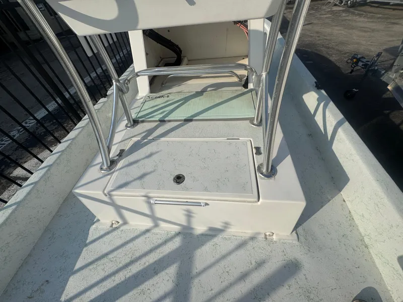 Slide: The Image of 2013 Shallow Sport 21 Sport boat deck with storage compartment and railing. - 6