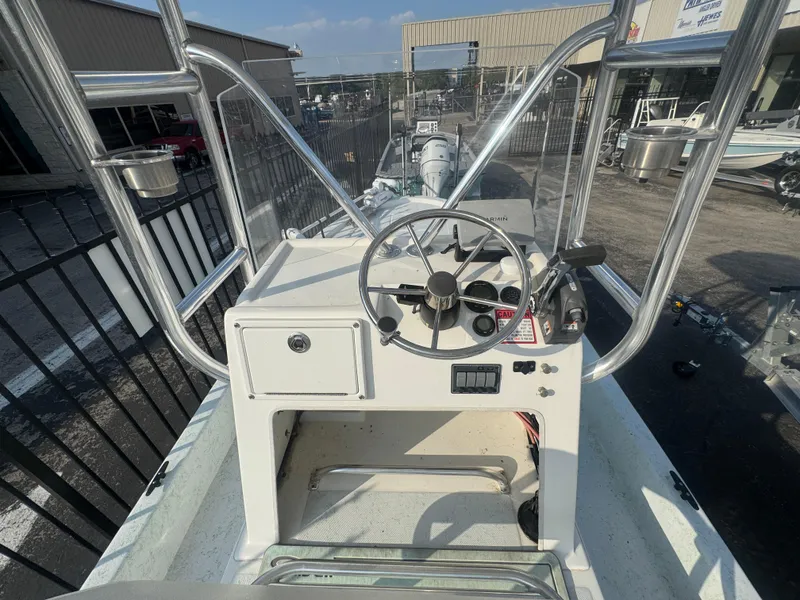 Slide: The Image of 2013 Shallow Sport 21 Sport boat console with steering wheel and controls. - 7