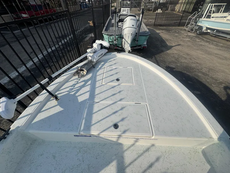 Slide: The Image of 2013 Shallow Sport 21 Sport boat deck with storage compartments and trolling motor. - 8