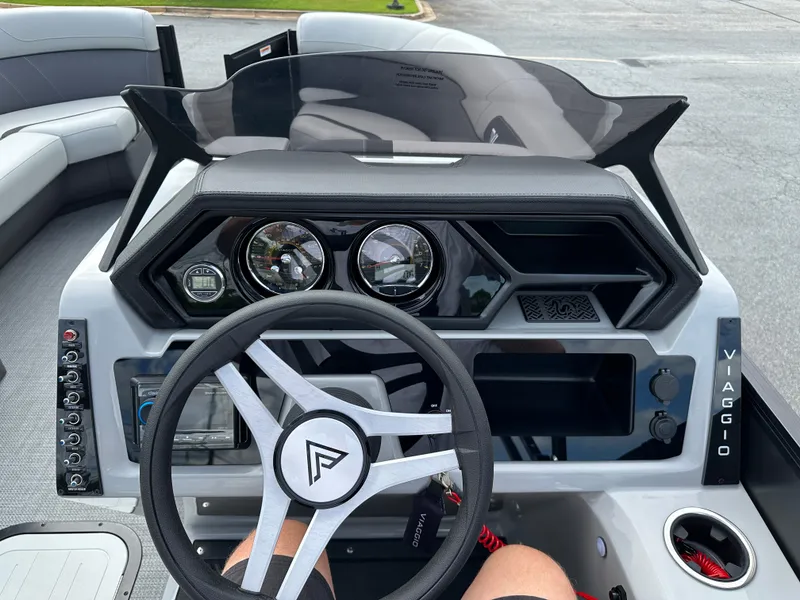 Slide: The Image of 2025 Viaggio Lago X-S boat dashboard with modern steering wheel and instrument panel. - 13