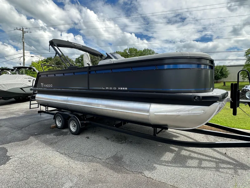 Slide: The Image of 2025 Viaggio Lago X-S pontoon boat on trailer under cloudy sky. - 6