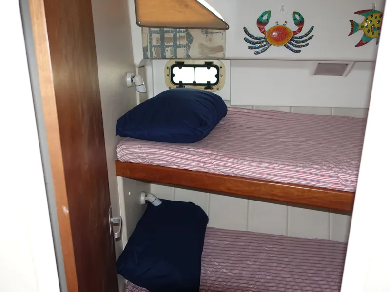 Slide: The Image of Bunk beds in 1998 Mainship 31 Sedan Bridge cabin with nautical decor. - 23