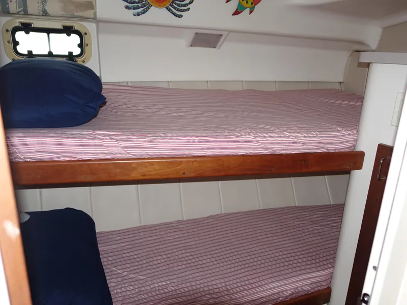 Slide: The Image of Bunk beds in 1998 Mainship 31 Sedan Bridge cabin with nautical decor. - 25