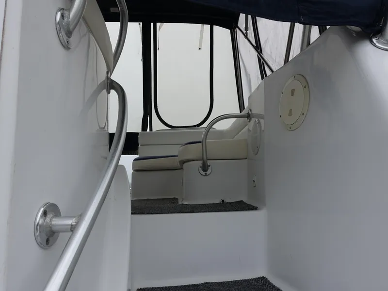 Slide: The Image of 1998 Mainship 31 Sedan Bridge interior with seating and handrails. - 3